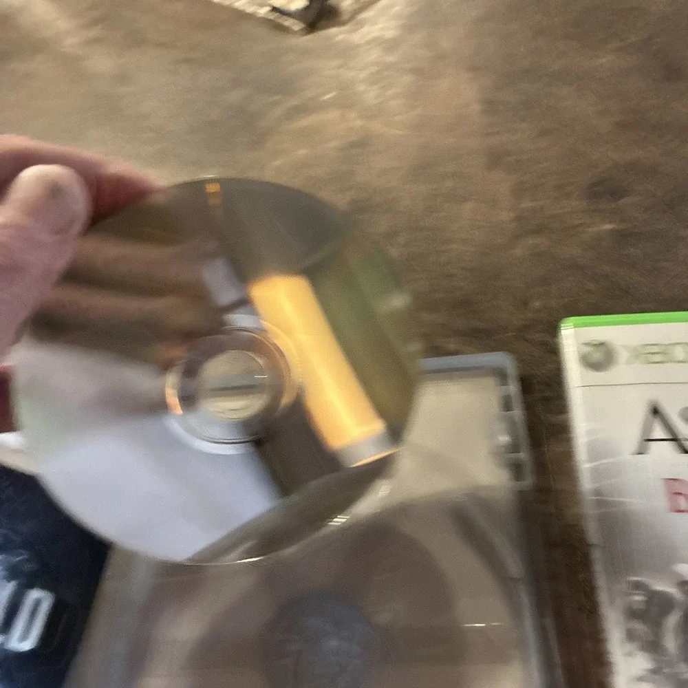 Three Xbox 360 Games, Assassin Creed, Battlefield, And Call Of Duty